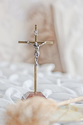 A brass crucifix featuring Jesus Christ, symbolizing faith and devotion. HD phone wallpaper