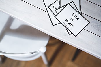 Minimalist black and white quote cards on a light wooden desk, perfect for design concepts. HD wallpaper