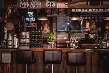 Cozy bar interior featuring Route 66 decor, rustic design elements, and classic signage. HD wallpaper