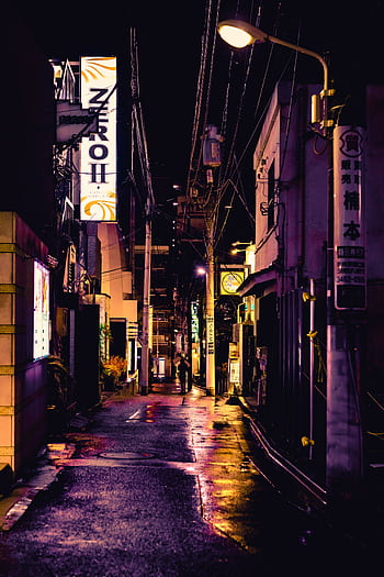 A captivating street scene in Shinjuku, Tokyo, showcasing vibrant neon lights on a rainy night. HD phone wallpaper