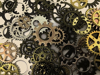Close-up view of various interlocking gears showcasing intricate industrial design and precision. HD wallpaper