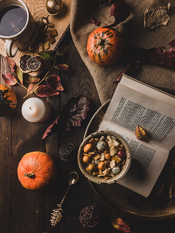 Warm and rustic autumn scene with pumpkins, tea, and dried leaves on a wooden table. HD phone wallpaper