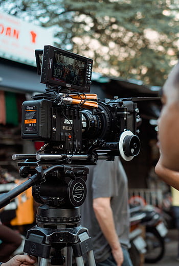 Close-up of professional video camera and crew on an outdoor film set. HD phone wallpaper