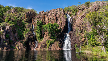 Landscape View Of Waterfall From Rocks Green Trees Bushes Grass Blue Sky Background Reflection On Water Nature HD wallpaper