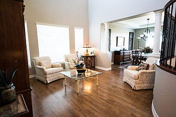 Spacious living room featuring classic furniture and elegant decor in a modern home setting. HD wallpaper