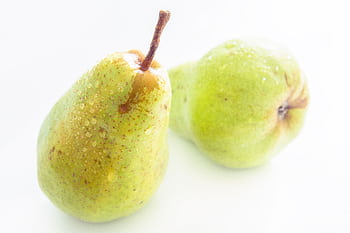 Close-up of fresh, juicy pears with dew drops, showcasing their freshness and vibrant color. HD wallpaper
