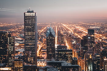 Aerial view of Chicago's illuminated skyline at dusk, showcasing vibrant city lights. HD wallpaper