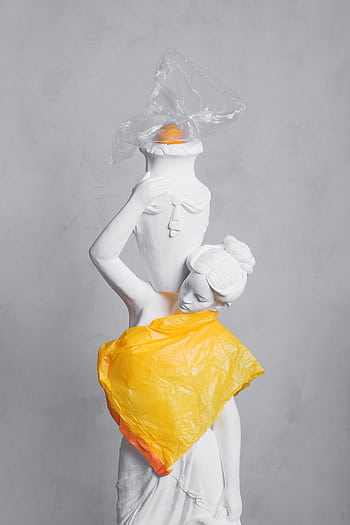 A white statue wrapped in vibrant plastic bags highlighting modern pollution. HD phone wallpaper