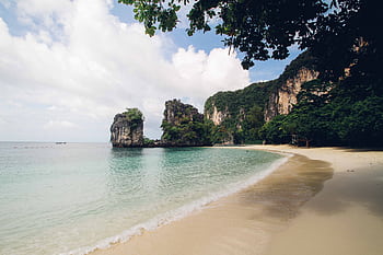 Tranquil beach scene with limestone cliffs in Thailand, perfect for tropical escapes. HD wallpaper