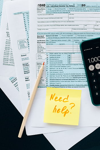 Close-up of tax forms with a calculator and a note asking for assistance. HD phone wallpaper