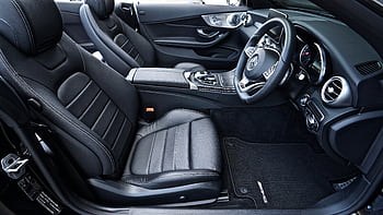 Sleek black Mercedes-Benz interior featuring leather seats and modern dashboard design. HD wallpaper