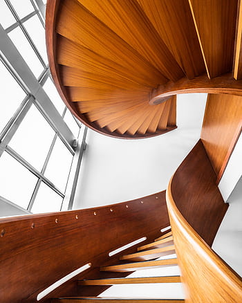 Beautiful wooden spiral staircase with modern design and glass windows in a bright interior. HD phone wallpaper