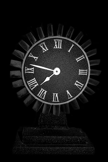 Stylish black clock with Roman numerals against a dark background. HD phone wallpaper