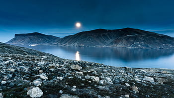 Breathtaking moonlit view of Baffin Island's rugged landscape and tranquil waters. HD wallpaper