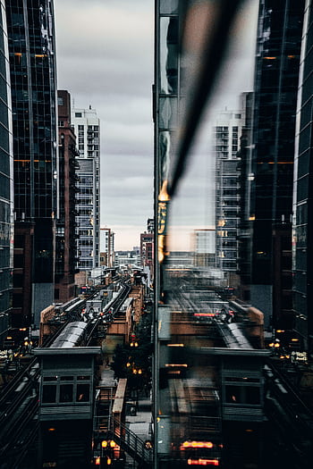 View of Chicago's elevated train with city reflections at twilight. HD phone wallpaper