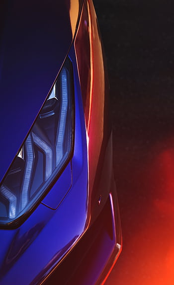Vibrant close-up of a luxury sports car headlight featuring lens flare and reflections. HD phone wallpaper