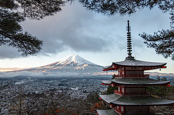 Scenic view of Chureito Pagoda with snow-capped Mount Fuji under a cloudy sky in Fujinomiya, Japan. HD wallpaper