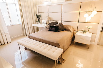 Luxurious modern bedroom featuring elegant design elements, soft lighting, and cozy bedding. HD wallpaper