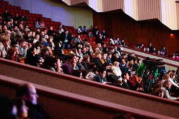 Engaged audience seated indoors, captured with a Canon camera. Ideal for event coverage visuals. HD wallpaper