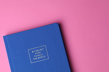 Stylish blue notebook on pink background with inspiring text cover. HD wallpaper