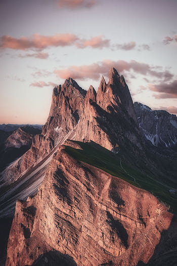 Breathtaking view of the sharp peaks of Seceda in the Dolomites during twilight, highlighting natural beauty. HD phone wallpaper