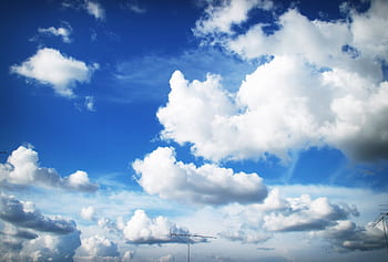 Vivid blue sky filled with fluffy white clouds, perfect for a serene atmosphere. HD wallpaper