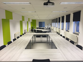 Spacious indoor meeting room with modern furniture and large windows. HD wallpaper