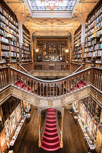 Stunning view of the iconic Livraria Lello's grand staircase and bookshelves in Porto, Portugal. HD phone wallpaper