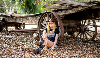 ~Cowgirl~, wagon, 45 Revolver, cowgirl, blonde, guns, wheels, handguns, wagon wheels, leaves, wood, Gold 45 Revolver, boots, hat HD wallpaper