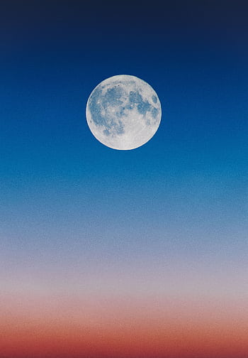A serene full moon set against a gradient twilight sky, blending hues of blue and orange. HD phone wallpaper