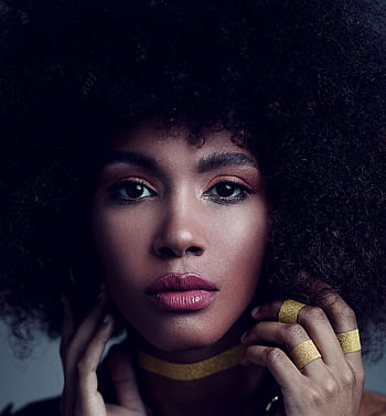 Captivating studio portrait of a woman with afro hair, wearing stylish makeup and jewelry. HD phone wallpaper