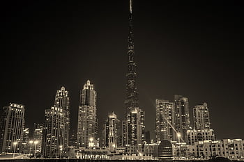 Captivating black and white night view of Dubai's skyline with the iconic Burj Khalifa illuminated. HD wallpaper