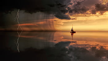 A striking seascape featuring a sailboat, lightning, and storm clouds at sunset. HD wallpaper