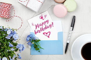 Celebratory birtay setup with a card, flowers, and coffee on a desk. HD wallpaper