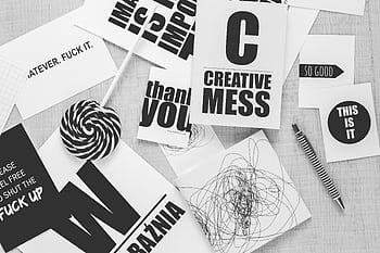 Monochrome desk scene with creative typography, candies, and a striped pen. HD wallpaper