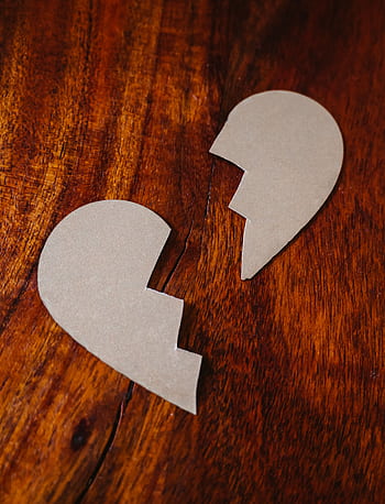 Cardboard broken heart symbol on wooden table, representing love and separation. HD phone wallpaper