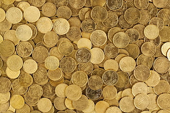 A close-up shot of Euro coins scattered in a pile, showcasing a rich golden texture. HD wallpaper