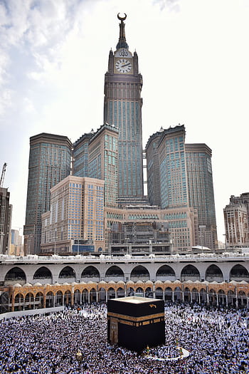 Stunning view of Abraj Al Bait towering over the Kaaba and Masjid Al Haram in Mecca. HD phone wallpaper