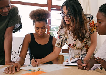 A group of diverse professionals collaborates on a project, fostering teamwork and creativity. HD wallpaper