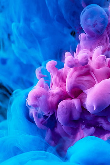 Dynamic pink and blue ink swirls creating a vibrant abstract texture. HD phone wallpaper