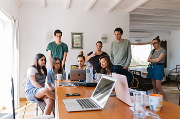 Group of young professionals engaged in a collaborative meeting in a modern office setting. HD wallpaper
