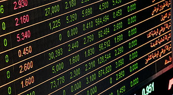 Detailed view of a stock market screen showing numbers and data, symbolizing financial trading. HD wallpaper