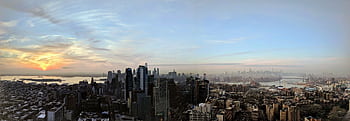 Stunning panoramic view of New York City skyline from Brooklyn at sunset, featuring iconic landmarks and skyscrapers. HD wallpaper