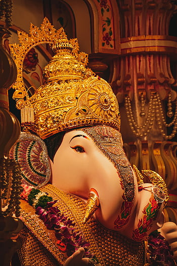 Intricately decorated Ganesha statue in a Pune temple showcasing vibrant cultural religious art. HD phone wallpaper