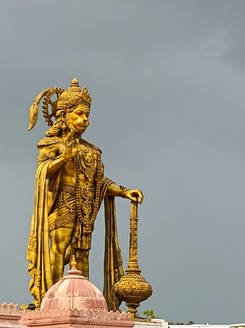 Stunning vertical shot of the golden Hanuman statue in Sarangpur, India, illustrating Hindu culture. HD phone wallpaper