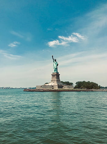 Iconic Statue of Liberty on Liberty Island, a famous landmark and UNESCO World Heritage Site. HD phone wallpaper