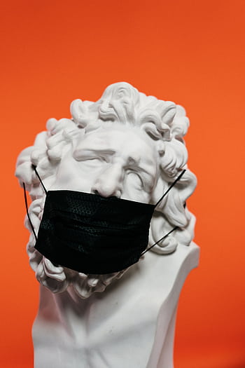 A marble bust adorned with a black face mask set against an orange background. HD phone wallpaper