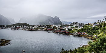 Misty harbor scene of charming village nestled along a tranquil coastline. HD wallpaper