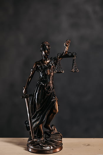 Elegant bronze Lady Justice statuette symbolizing law and justice. HD phone wallpaper