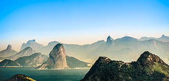 Breathtaking view of Rio de Janeiro's mountains and sea under a clear dusk sky. HD wallpaper
